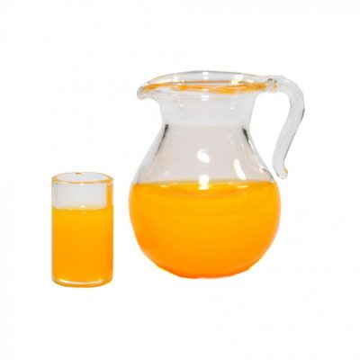 A glass of orange juice next to a full pitcher on a white background.