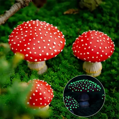 A collection of red, toadstool-like mushrooms with white spots, surrounded by green moss, featuring an inset of the mushrooms glowing in the dark.