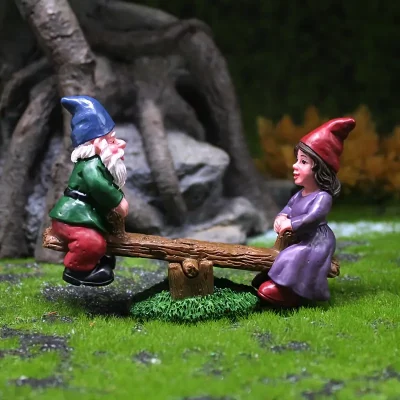 A whimsical scene featuring two garden gnomes, one in a green coat and blue hat, and the other in a purple dress and red hat, playing on a wooden seesaw amidst a grassy setting.